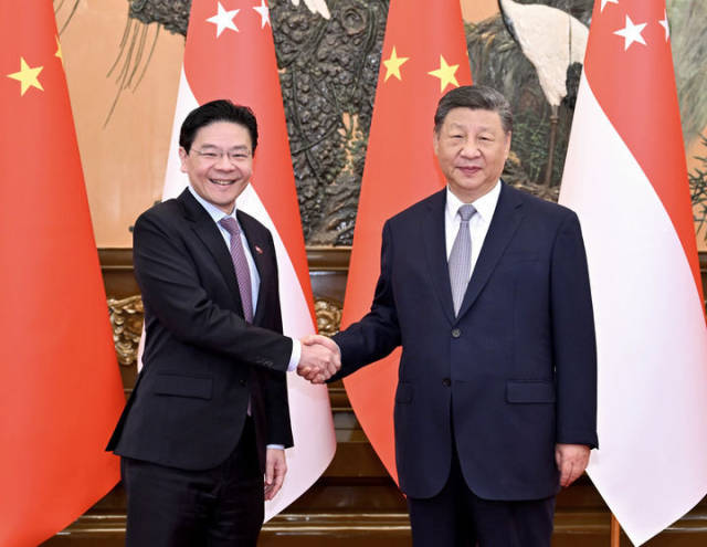 6月24日上午，国家主席习近平在北京人民大会堂会见来华进行正式访问的新加坡总理黄循财。新华社记者 岳月伟 摄